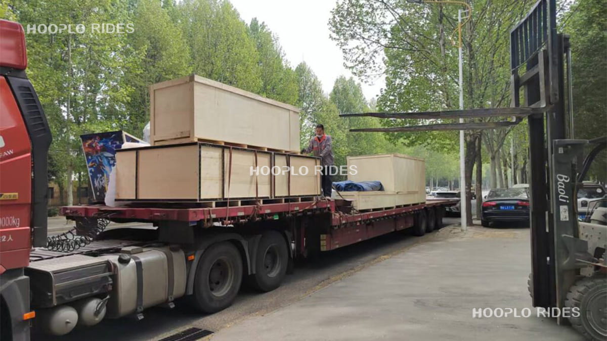 Packed amusement rides in wooden crates being loaded onto truck for shipment to Russia