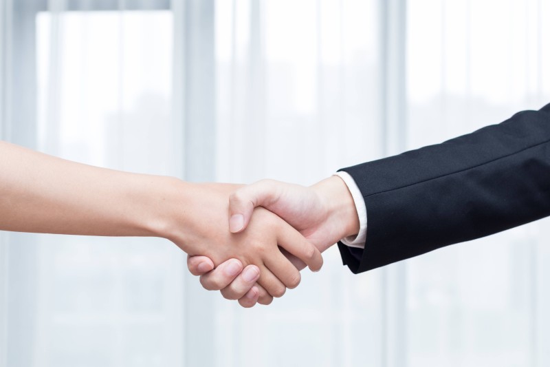 Close-up of a handshake representing trust, responsibility, and long-term partnership in the amusement business.