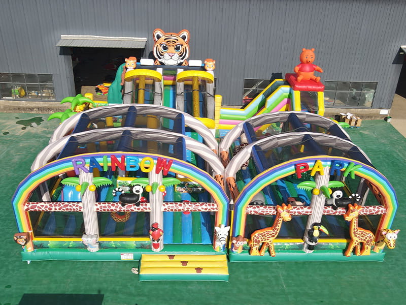 Rainbow Animal Park inflatable playground with colorful animal-themed elements and slides